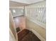 View from top of staircase shows hardwood flooring and bright paint, looking into open living area at 4709 E New York St, Indianapolis, IN 46201
