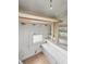 Unfinished attic space featuring wooden support beams and a window at 4715 E New York St, Indianapolis, IN 46201