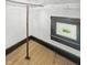 Unfinished attic room with a window and hardwood flooring at 4715 E New York St, Indianapolis, IN 46201