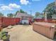 Backyard space with red fence, a small garage and a light brown hot tub at 4715 E New York St, Indianapolis, IN 46201
