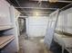 Unfinished basement space with exposed ceiling and a utility sink at 4715 E New York St, Indianapolis, IN 46201