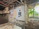 Electrical circuit breaker box mounted on brick basement wall with natural light from a window at 4715 E New York St, Indianapolis, IN 46201