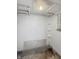 White-painted basement bathroom with partial shower, basic plumbing, and unfinished floors at 4715 E New York St, Indianapolis, IN 46201