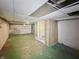 Spacious unfinished basement with a shower, paneled walls, and an open ceiling at 4715 E New York St, Indianapolis, IN 46201