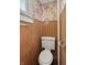 A powder room showcasing wood paneling and floral wallpaper at 4715 E New York St, Indianapolis, IN 46201