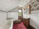 Vintage bathroom featuring floral wallpaper, a classic sink, and a bathtub at 4715 E New York St, Indianapolis, IN 46201