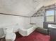 Bathroom with a tub, toilet, sink and wood paneled walls at 4715 E New York St, Indianapolis, IN 46201