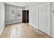 Bedroom with hardwood floors, natural light from a window, and neutral walls at 4715 E New York St, Indianapolis, IN 46201