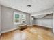 Bedroom with hardwood floors, natural light from the windows, and an open closet at 4715 E New York St, Indianapolis, IN 46201