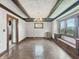 Charming dining room boasts a coffered ceiling, hardwood floors, and large windows with beautiful wrought iron details at 4715 E New York St, Indianapolis, IN 46201