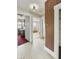 Hallway with multiple entryways, wood paneling, and vintage charm at 4715 E New York St, Indianapolis, IN 46201