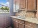 This vintage-style kitchen features wood cabinets, a double sink, and plenty of natural light at 4715 E New York St, Indianapolis, IN 46201