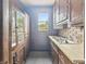 This kitchen features wood cabinets, a brick backsplash, and a window at 4715 E New York St, Indianapolis, IN 46201