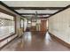 Expansive living room featuring dark beams, wood floors, and neutral paint at 4715 E New York St, Indianapolis, IN 46201