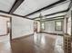 Spacious living room with wood floors, ceiling fan and dark wooden beams at 4715 E New York St, Indianapolis, IN 46201
