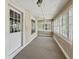 Inviting sunroom filled with natural light from many windows and a ceiling fan at 4715 E New York St, Indianapolis, IN 46201