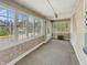 Charming sunroom featuring large windows, carpeted floor and a neutral color palette at 4715 E New York St, Indianapolis, IN 46201