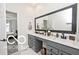 Modern bathroom featuring double sinks, quartz countertops, and a large framed mirror at 4726 Amber Wood Ln, Indianapolis, IN 46235