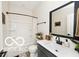 Modern bathroom with a single sink, a shower-tub combo, and neutral decor at 4726 Amber Wood Ln, Indianapolis, IN 46235