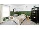 Cozy bedroom featuring a bed with neutral bedding, a window, and modern decor at 4726 Amber Wood Ln, Indianapolis, IN 46235