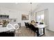 Dining area featuring modern lighting and a table for six, seamlessly connected to the kitchen at 4726 Amber Wood Ln, Indianapolis, IN 46235