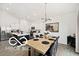 Open-concept design showcasing a dining area with modern lighting and views into the kitchen at 4726 Amber Wood Ln, Indianapolis, IN 46235