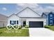 Charming single-story home with a well-manicured lawn, black garage door and neutral paint scheme at 4726 Amber Wood Ln, Indianapolis, IN 46235