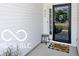 Inviting covered porch with black-trimmed door, and a welcome mat at 4726 Amber Wood Ln, Indianapolis, IN 46235