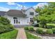 Beautiful backyard of a white home with a manicured lawn and lush landscaping at 4810 Crystal River Ct, Indianapolis, IN 46240