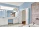 Bright bathroom featuring double sinks, vanity, a soaking tub, and a glass-enclosed shower at 4810 Crystal River Ct, Indianapolis, IN 46240
