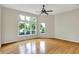 Bright, spacious bedroom with hardwood floors and large windows offering a scenic view at 4810 Crystal River Ct, Indianapolis, IN 46240