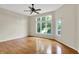 Bright, spacious bedroom with hardwood floors and large windows offering a scenic view at 4810 Crystal River Ct, Indianapolis, IN 46240
