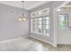 Sunlit dining room with neutral walls, tile floors, and a chandelier at 4810 Crystal River Ct, Indianapolis, IN 46240