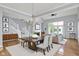 Elegant dining room with hardwood floors, modern chandelier and staircase at 4810 Crystal River Ct, Indianapolis, IN 46240