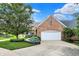 Charming brick home featuring a two-car garage and beautifully landscaped front yard at 4810 Crystal River Ct, Indianapolis, IN 46240