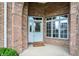 Inviting brick entryway with a white front door and sidelight window at 4810 Crystal River Ct, Indianapolis, IN 46240