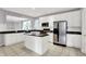 Bright kitchen with white cabinets, stainless steel appliances, and a breakfast bar at 4810 Crystal River Ct, Indianapolis, IN 46240