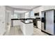 Bright kitchen with white cabinets, stainless steel appliances, and a breakfast bar at 4810 Crystal River Ct, Indianapolis, IN 46240