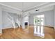 Spacious living room with a fireplace, hardwood floors, and French doors at 4810 Crystal River Ct, Indianapolis, IN 46240