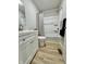 Bathroom featuring a shower with a patterned curtain, a modern vanity, and wood-look floors at 5 Watson Dr, Trafalgar, IN 46181