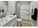Bathroom with modern vanity, tub with shower, and a decorative plant at 5 Watson Dr, Trafalgar, IN 46181
