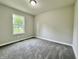 Bright bedroom with plush carpeting and a large window providing natural light at 5 Watson Dr, Trafalgar, IN 46181