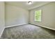 Bright bedroom with plush carpeting and a large window providing natural light at 5 Watson Dr, Trafalgar, IN 46181