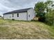View of the rear exterior of the house with a wooden deck at 5 Watson Dr, Trafalgar, IN 46181