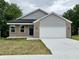 View of the exterior of the house with an attached garage at 5 Watson Dr, Trafalgar, IN 46181