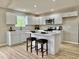 Bright kitchen with white cabinets, an island, and stainless steel appliances at 5 Watson Dr, Trafalgar, IN 46181