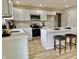 Open kitchen featuring an island with seating and modern appliances at 5 Watson Dr, Trafalgar, IN 46181