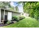 Backyard with garage, gardens, stone walkways, lush green grass, and tranquil landscaping at 5119 Norwaldo Ave, Indianapolis, IN 46205