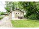 Charming backyard with a patio, complemented by lush greenery and a detached house at 5119 Norwaldo Ave, Indianapolis, IN 46205