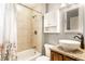 Bathroom featuring tub/shower with neutral tile, and granite countertop with bronze faucet at 5119 Norwaldo Ave, Indianapolis, IN 46205